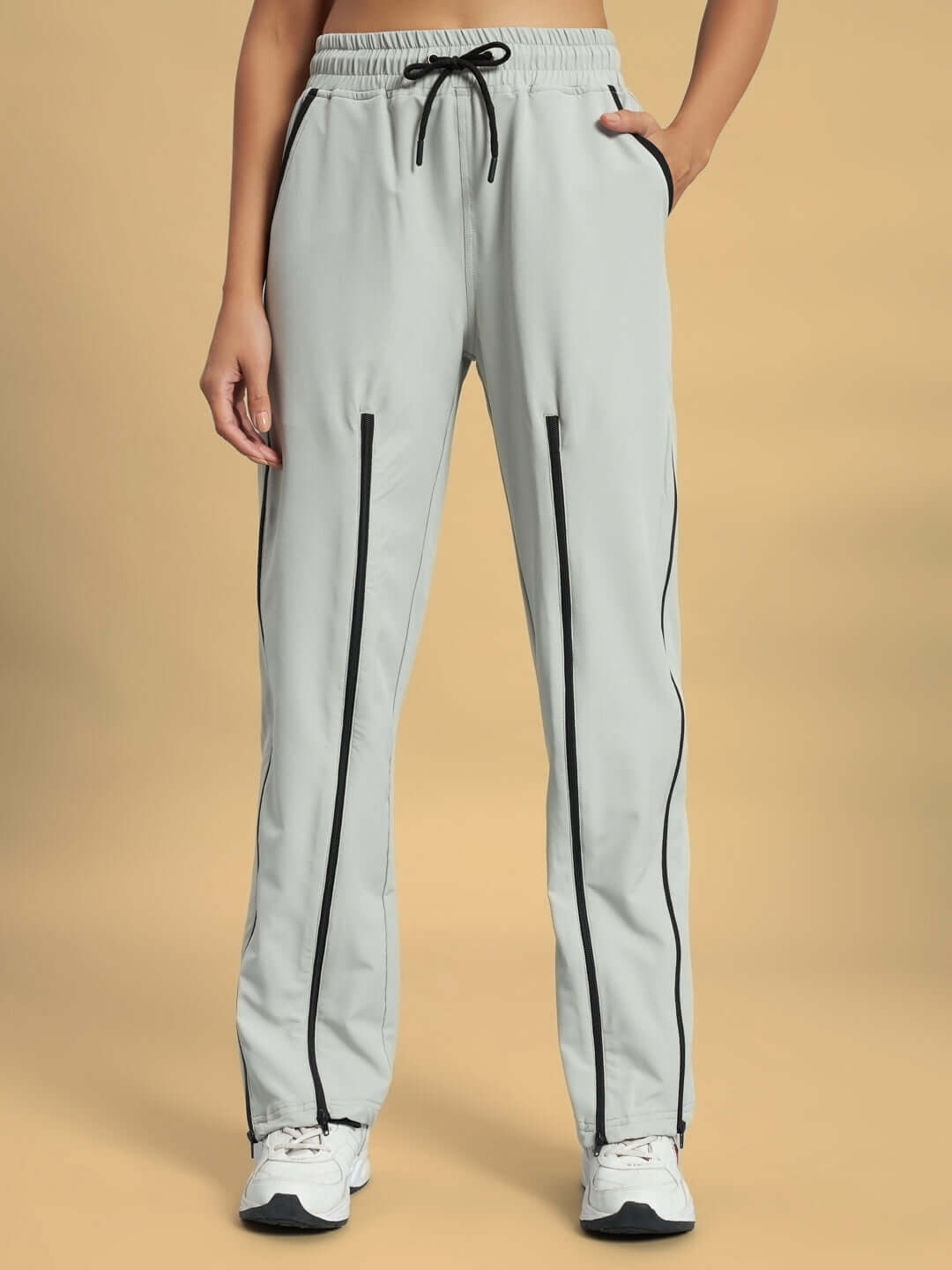 Women's grey primo parachute cargo pants with black drawstring and stripe design for versatile style and comfort.