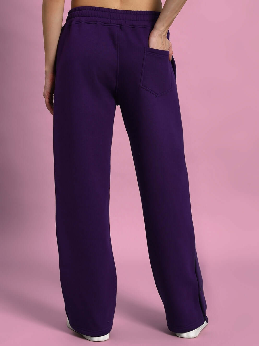 Back view of WOMEN SOOTY FLEECE CARGO PANT PURPLE with elastic waistband and pocket, showcasing streetwear style.