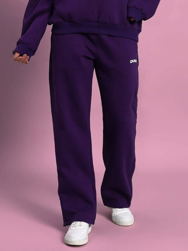 Woman wearing WOMEN SOOTY FLEECE CARGO PANT PURPLE with relaxed fit and stylish design.