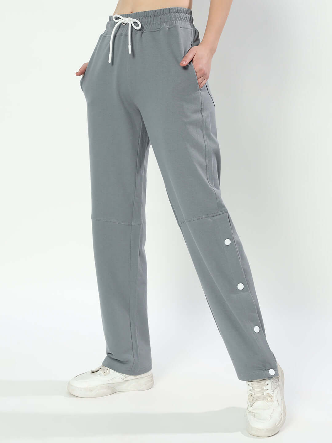 Women's grey racer joggers with custom fit option, made to order, featuring button details, styled with white sneakers.