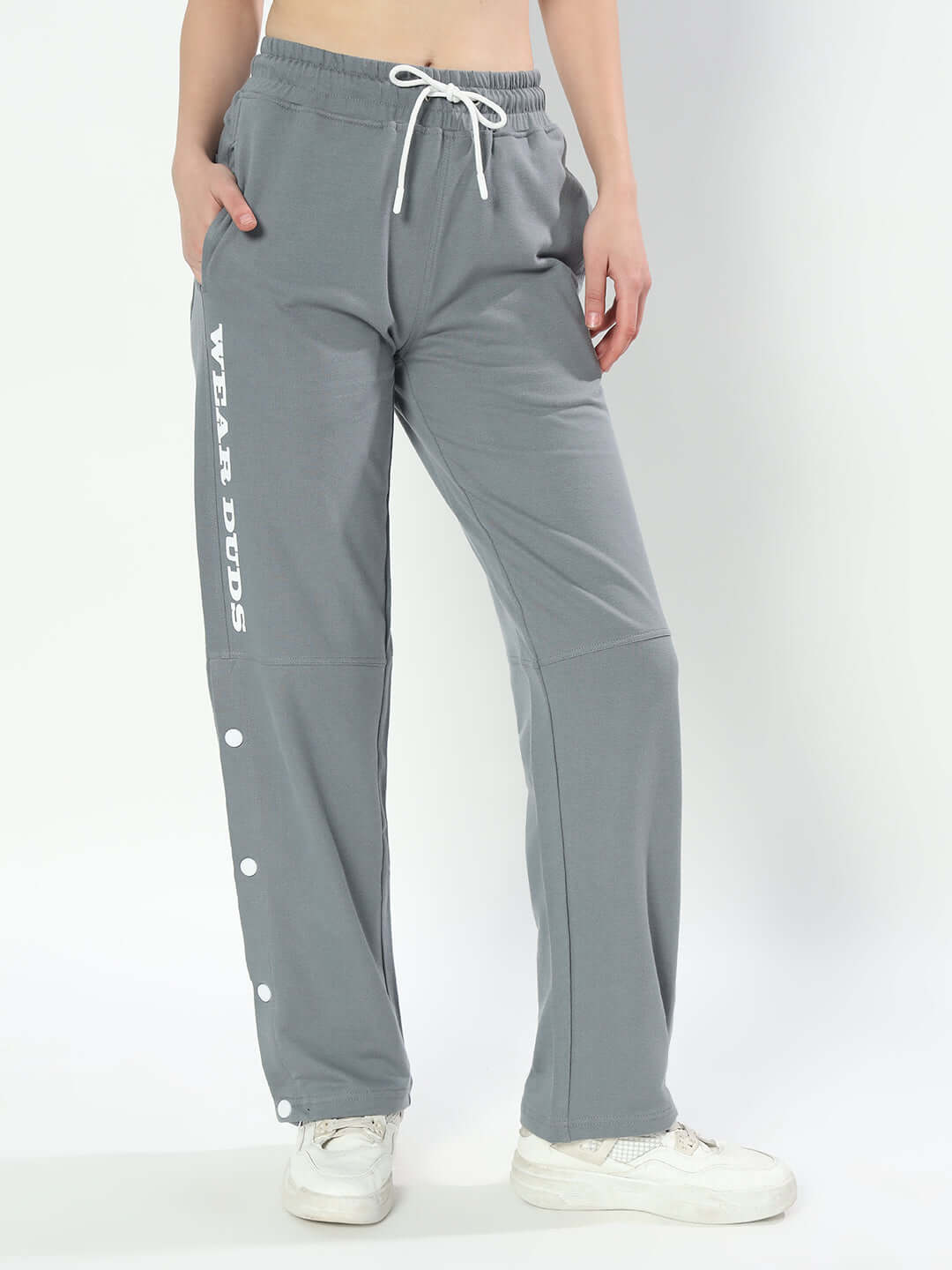 Grey women's racer joggers by DUDS with customizable fit, designed for comfort and style, featuring side snaps and lettering detail.
