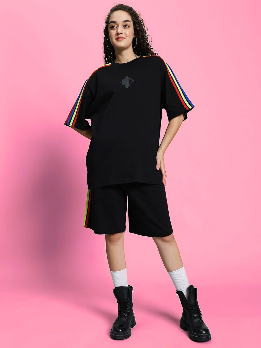 Model wearing women's black rainbow summer co-ord set with striped sleeves, made from premium cotton and elastane. Casual fashion.