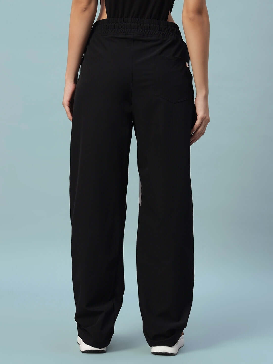 Back view of Women's Ranger Relaxed Fit Cargo Pants in black, showcasing loose fit and pocket detail.