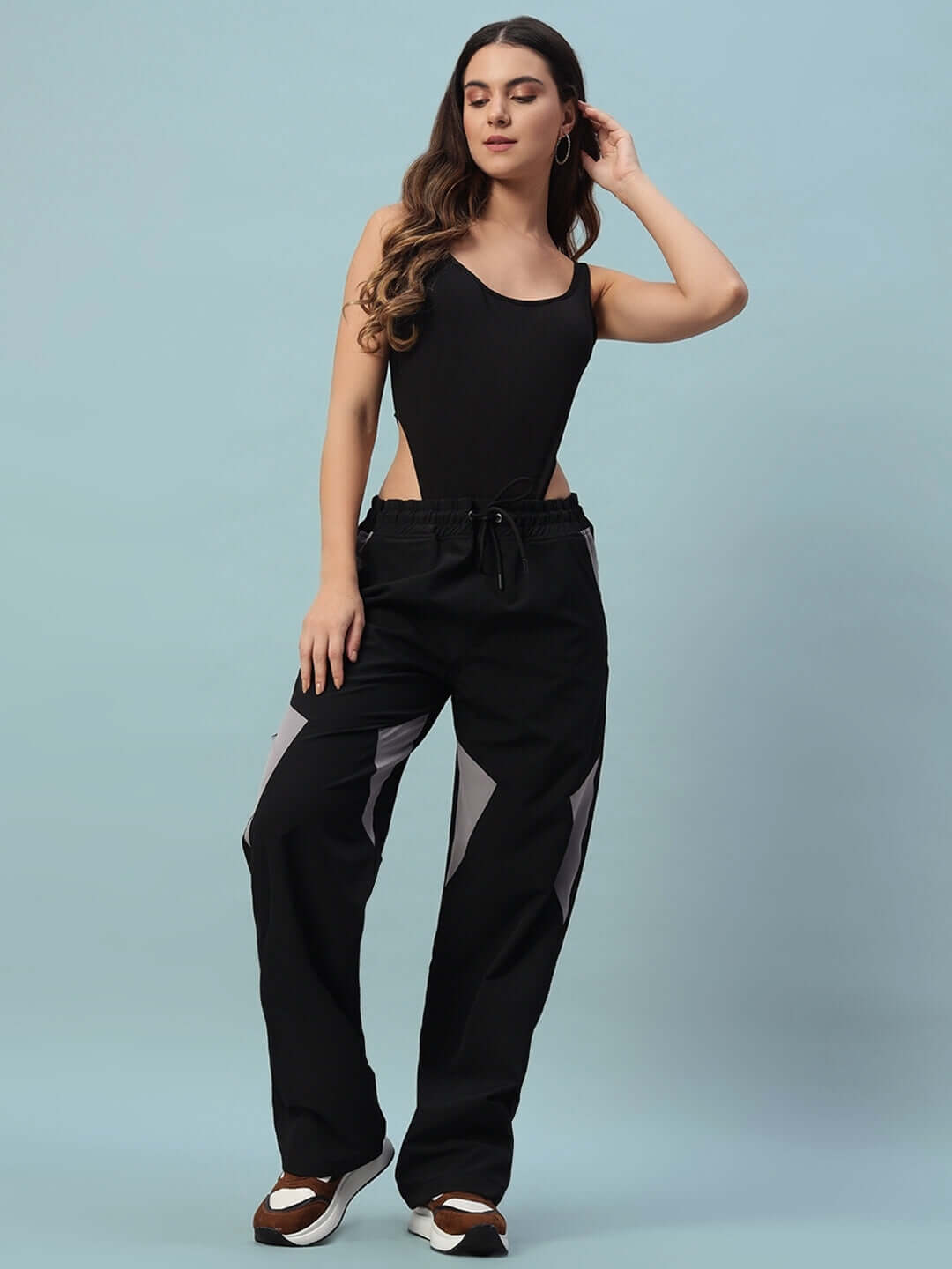 Model wearing women's black Ranger relaxed fit cargo pants, customizable size options available, perfect blend of comfort and style.