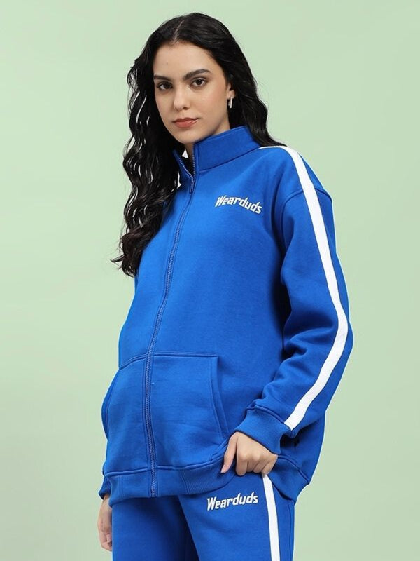 Woman wearing WOMEN'S RAPID STRIDE COTTON FLEECE JACKET ROYAL BLUE, showing side stripes and zippered front.