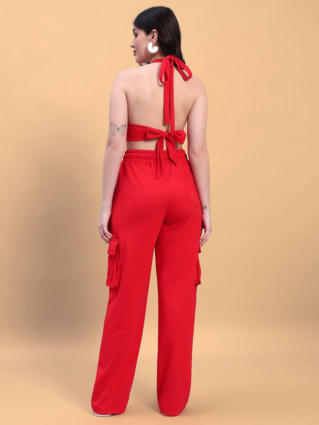 Back view of a woman wearing a red co-ord set with tie-back straps and cargo pockets, made from premium cotton blend.