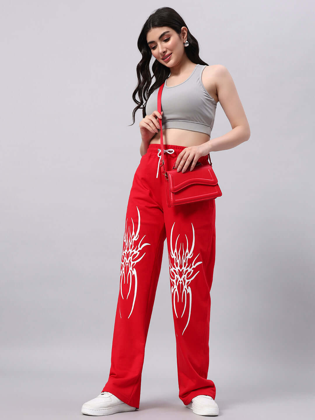 Woman wearing WOMEN'S REDX BRANCHING JOGGER RED with unique design and custom fit option, made to order by DUDS Tailors.