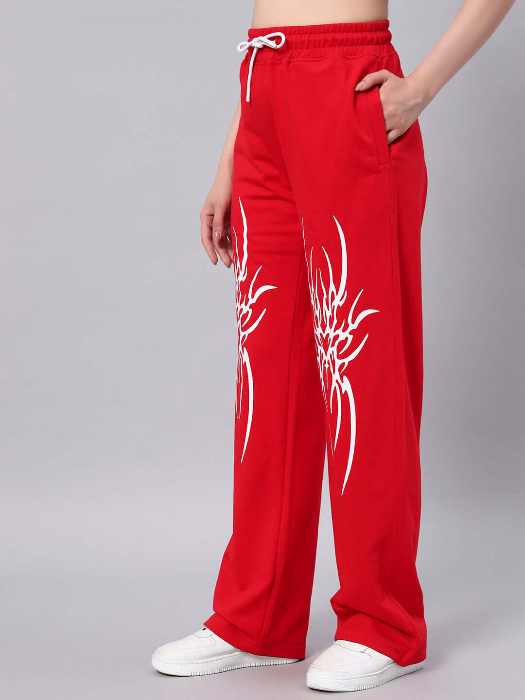 Model wearing WOMEN'S REDX BRANCHING JOGGER RED with branching design, side pockets, and drawstring waist for custom fit.