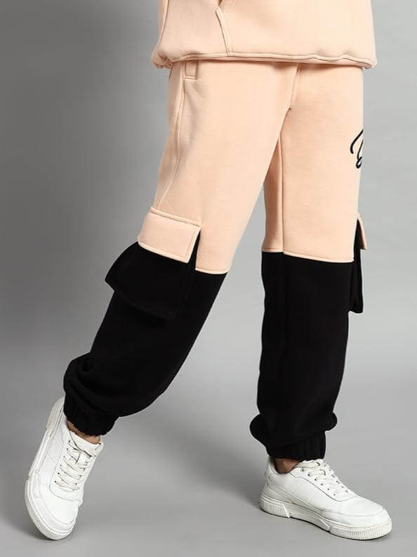 Women Regiment Fleece Pant Beige Black showcasing urban streetwear style with elastic waistband, ribbed hems, and side pockets.