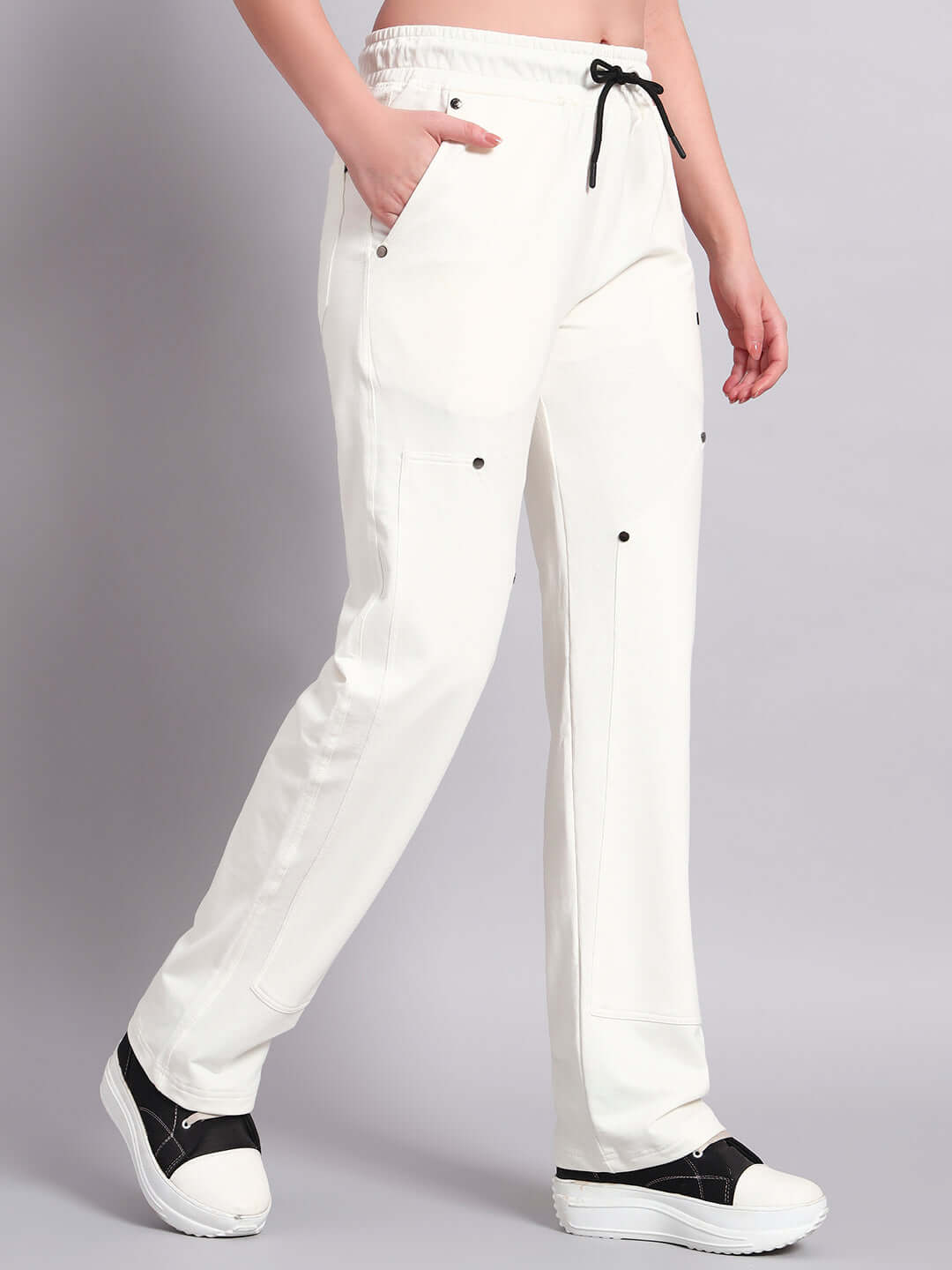 White women's relaxed-fit joggers by DUDS featuring adjustable drawstring waist, shown in side view for stylish comfort.