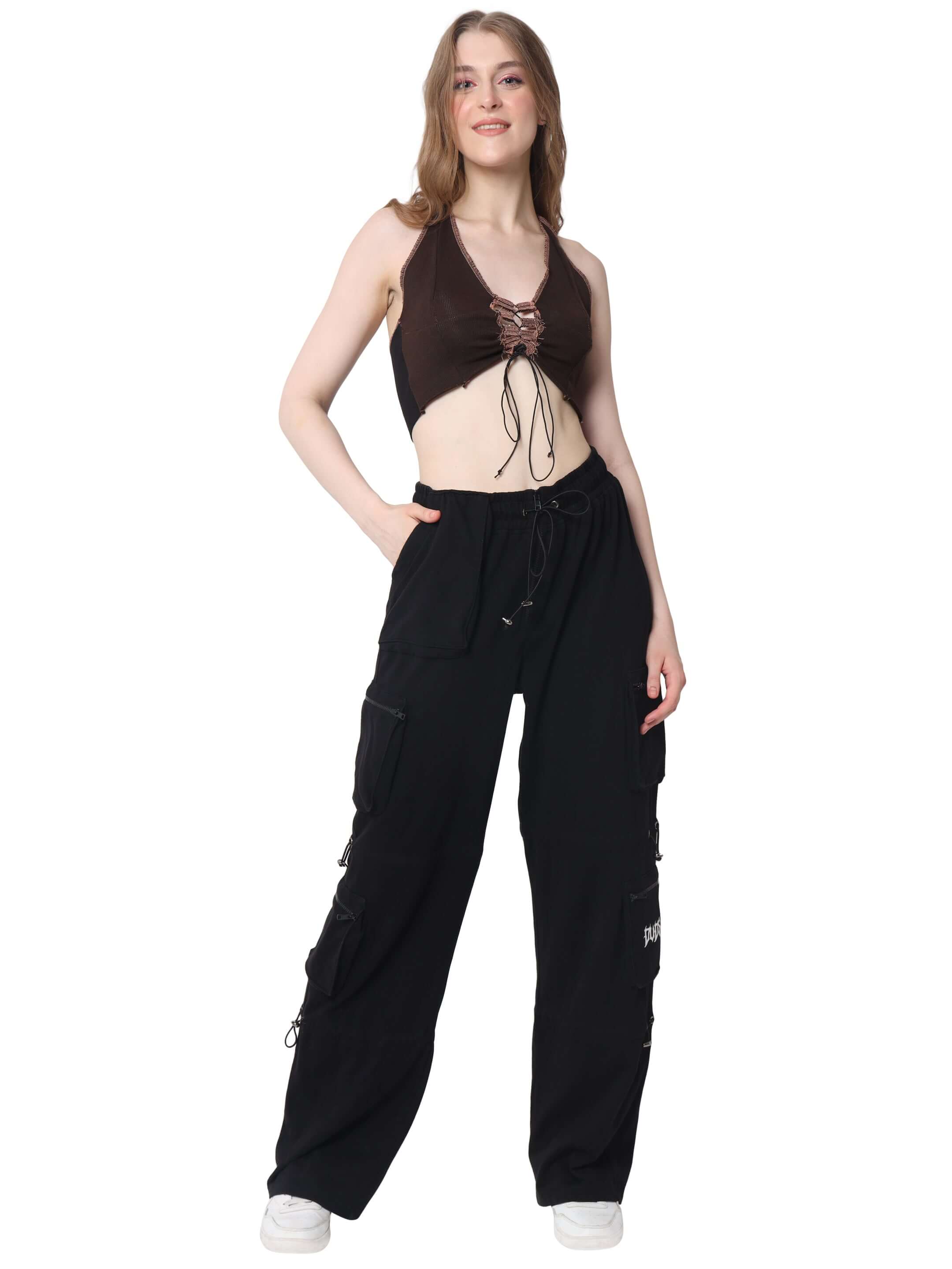 Woman wearing a brown ribbed crop-top paired with black cargo pants, showcasing a stylish casual outfit.