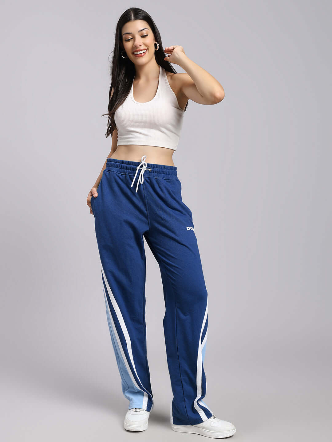 Woman wearing blue relaxed fit joggers from DUDS, showcasing casual comfort and style.