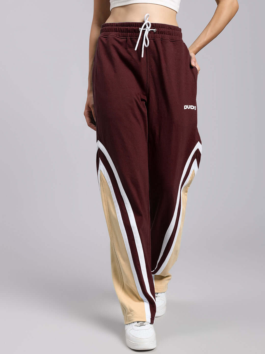 Woman wearing WOMENS RIO ONE RELAXED FIT JOGGERS MAROON with white sneakers