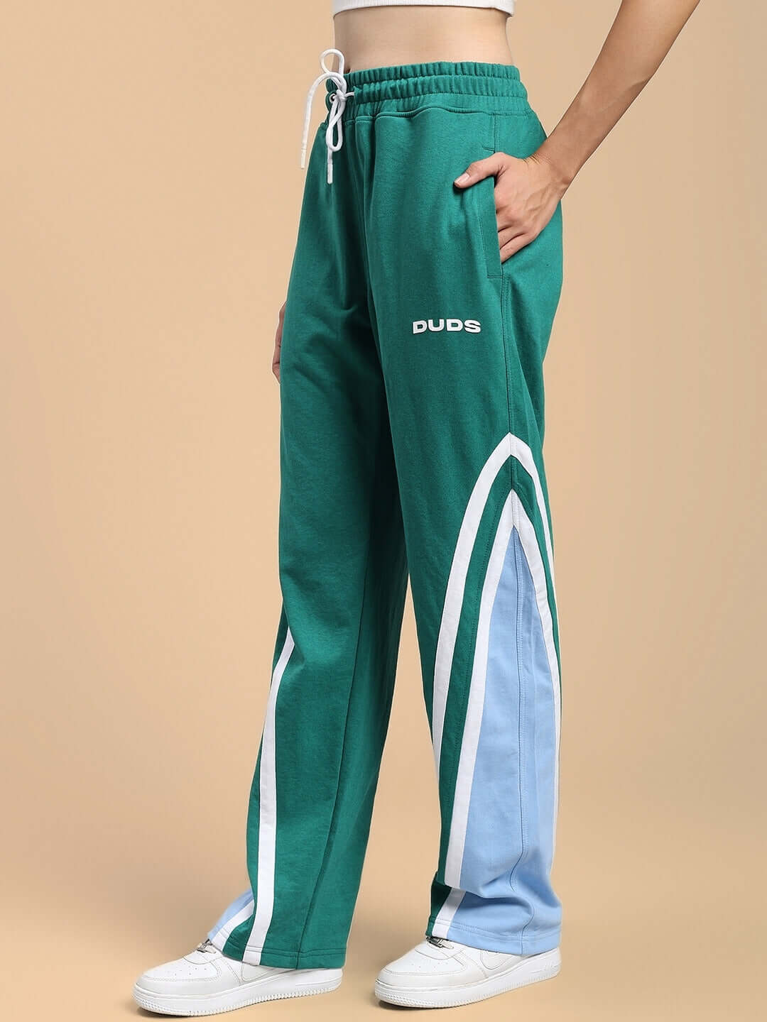 Teal green women's joggers with white and blue detail, relaxed fit, by DUDS, shown with white sneakers.