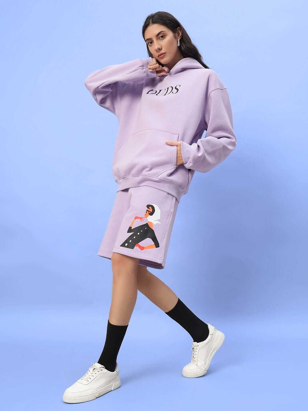 Woman wearing WOMEN RITZY FLEECE CO-ORD LILAC with hoodie and shorts in lilac color with artistic design.