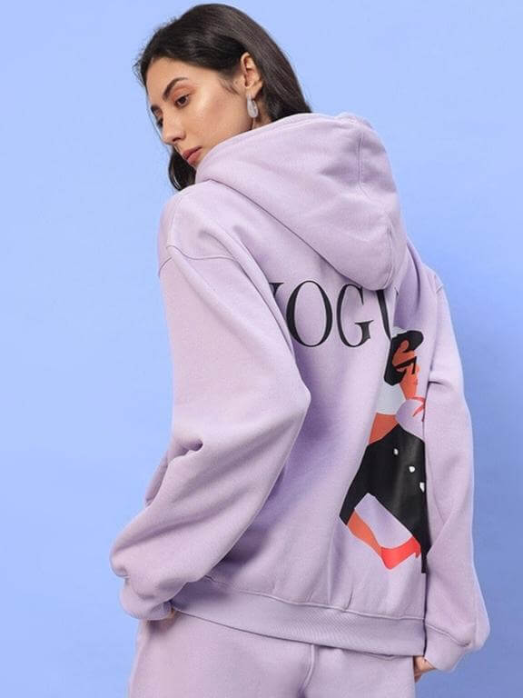 Woman wearing WOMEN RITZY FLEECE HOODIE LILAC with stylish back print, made to order by DUDS, tailored for a custom fit option available.