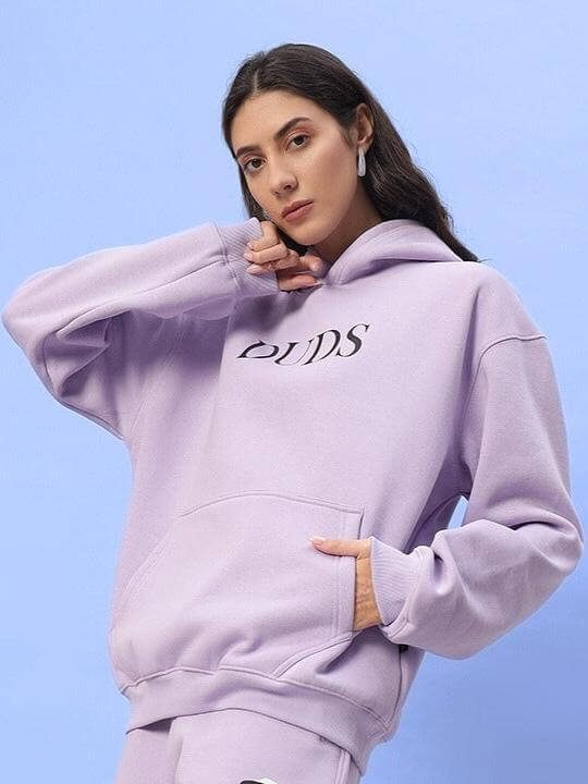 Woman wearing WOMEN RITZY FLEECE HOODIE LILAC by DUDS, featuring a soft lilac color and comfortable fit.