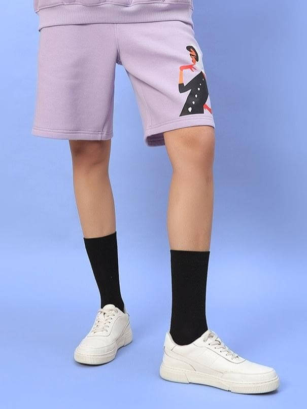 Model wearing WOMEN RITZY FLEECE SHORTS LILAC with graphic detail, showcasing a stylish lilac color, ideal for casual fashion.
