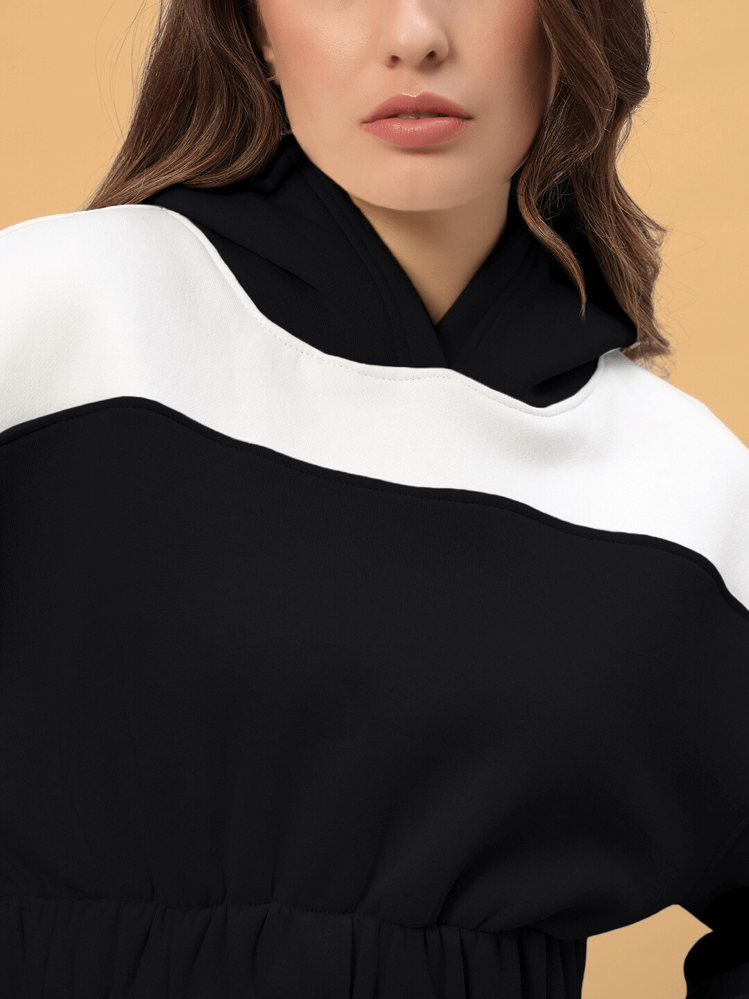 Close-up of a woman wearing a black and white Rizzler colorblock co-ord set from DUDS