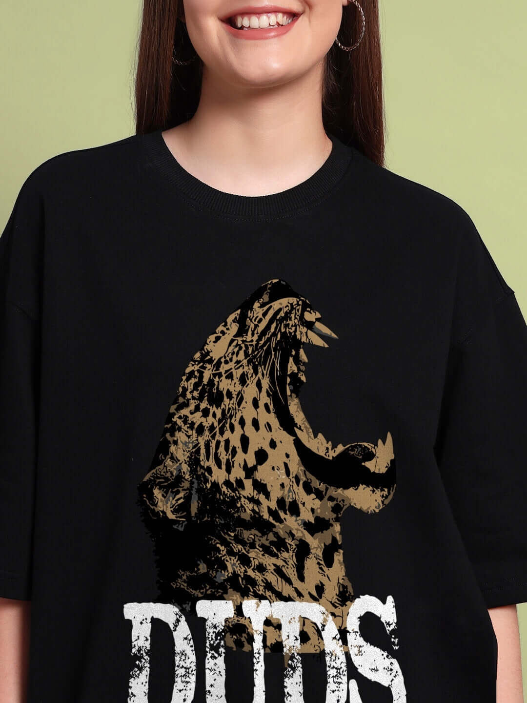 Woman wearing WOMENS ROARING THUNDER PRINTED OVERSIZED T-SHIRT BLACK with roaring leopard graphic.