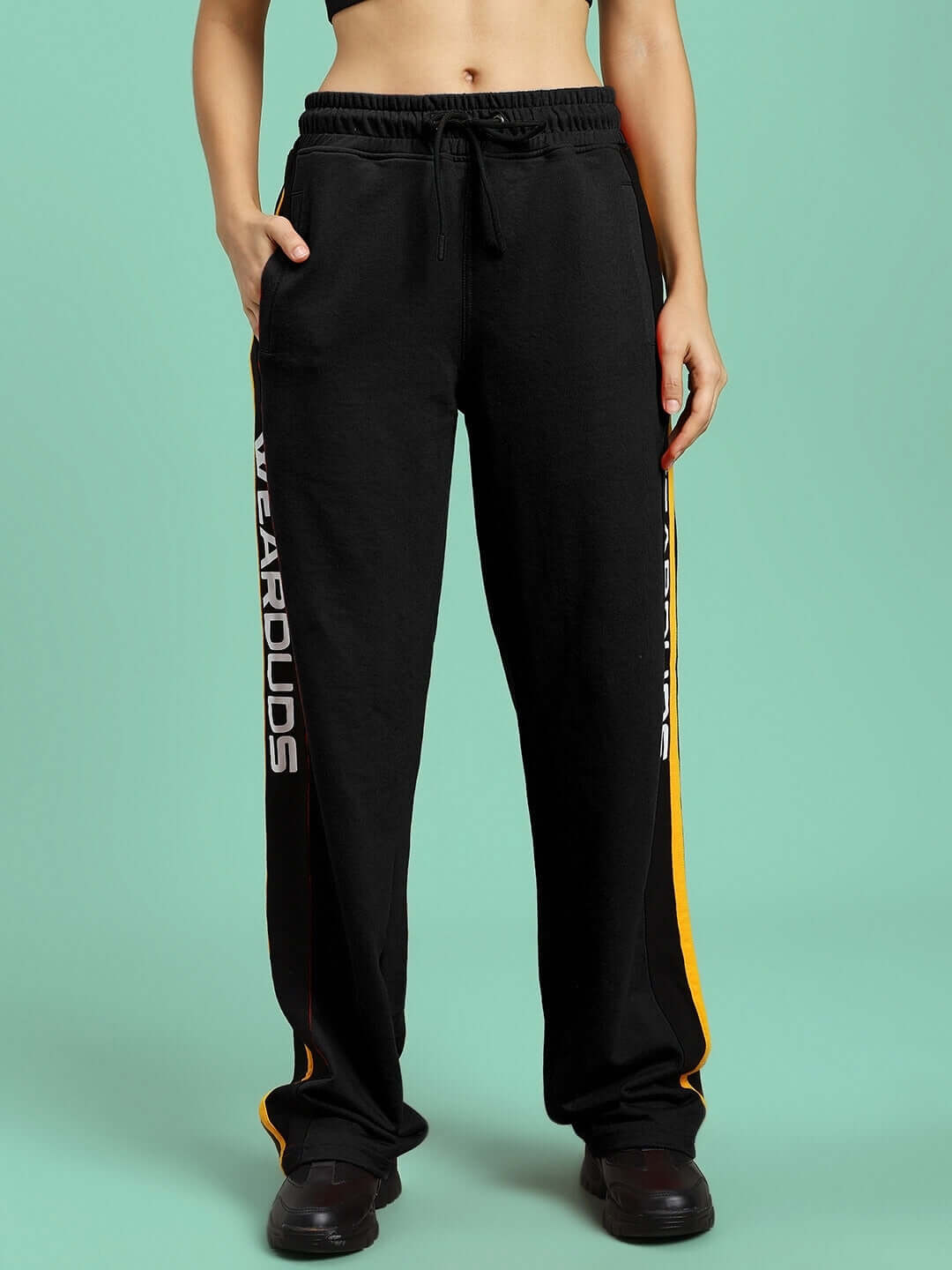 Women's black Roger relaxed-fit joggers by DUDS with side lettering, displayed on model, offering custom fit options.