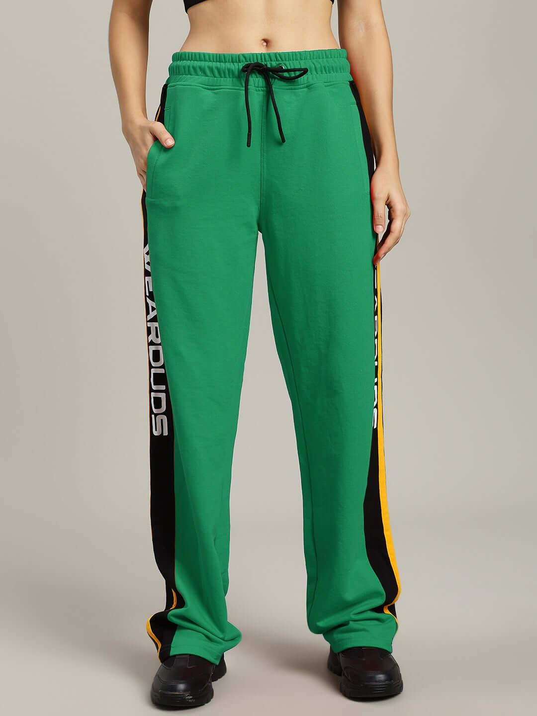 Women's green relaxed-fit joggers with black and yellow side stripes, featuring an adjustable drawstring waist, by Duds.