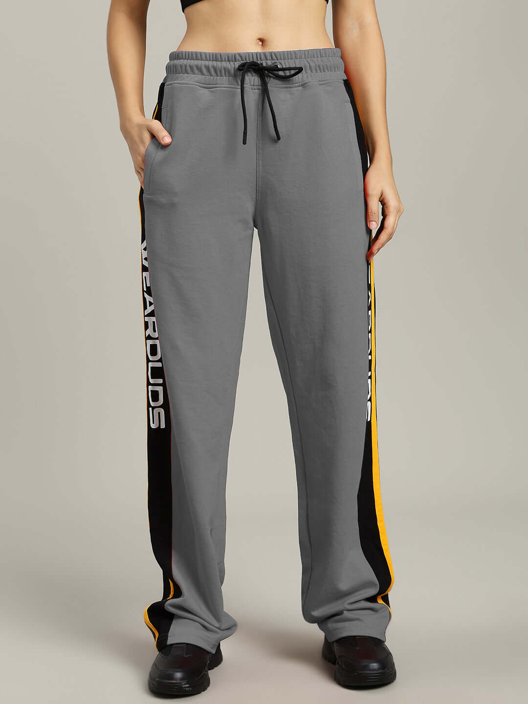 Alt Tag: Women's grey relaxed-fit joggers by DUDS featuring side stripes and drawstring waist, tailored for comfort and custom fit options.