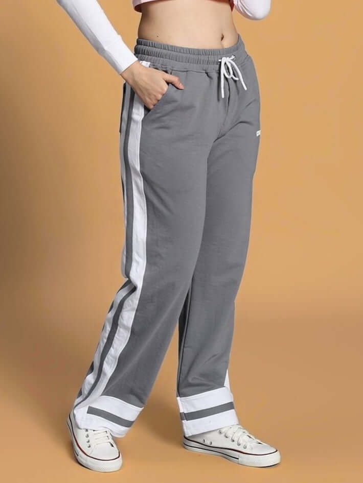 Woman wearing grey Ronny jogger with side stripe, paired with white sneakers.