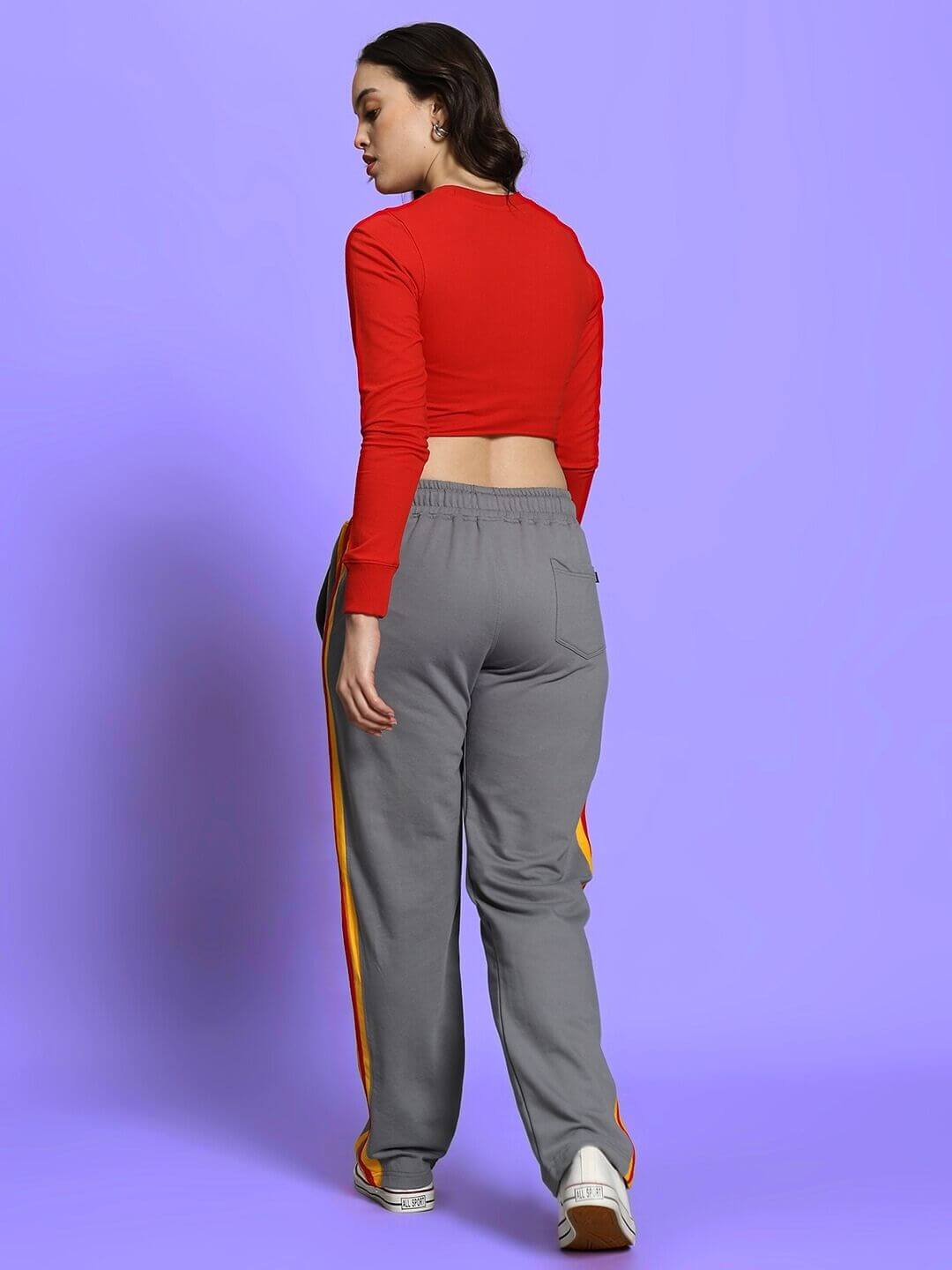 Model wearing red crop top and grey joggers with orange stripes, part of the Women's Rossi Racing Co-Ord Set.