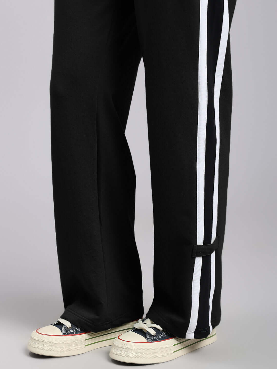 Alt Tag: WOMENS ROSSTON FLAT-OUT RELAXED FIT JOGGERS BLACK with white stripe details and casual sneakers for effortless style.