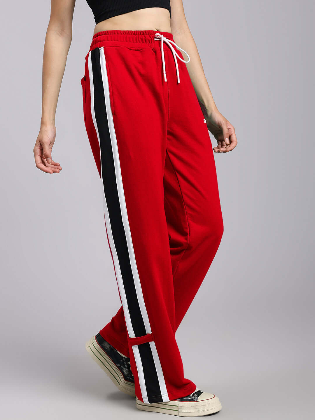 Red Women's Rosston Relaxed Fit Joggers with white and black side stripes, featuring a drawstring waist and casual sneakers.
