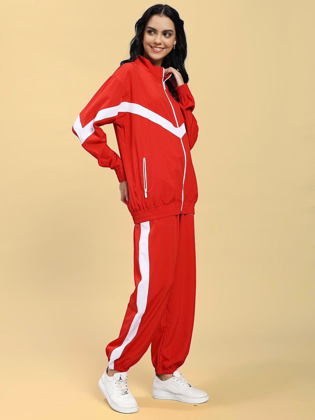 Woman wearing WOMEN ROYAL COMFORT RELAXED FIT CO-ORD SET RED with white sneakers, showcasing style and comfort.