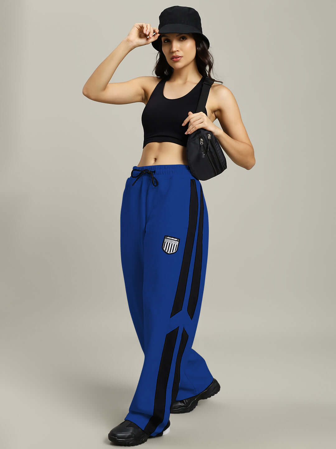 Woman modeling Women's Royalson Joggers in blue with black accessories, highlighting athletic style and comfort.