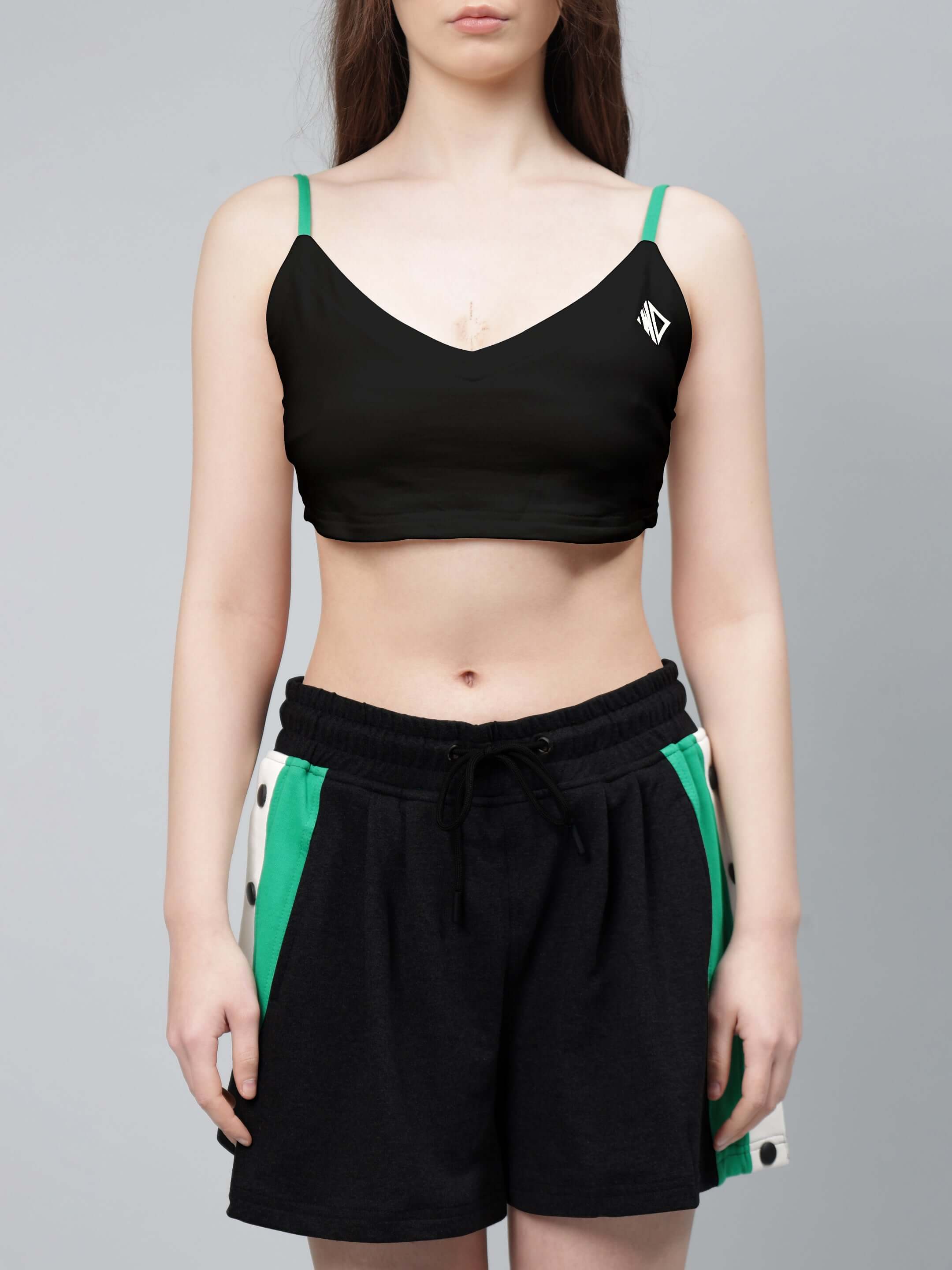 Model wearing WOMEN'S SAMMIE CO-ORD SET BLACK with green and black shorts and top, showcasing stylish and breathable fashion.
