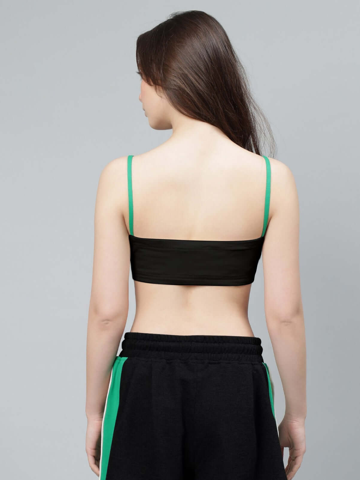Back view of a woman wearing a black Sammie crop-top made from premium heavy gauge cotton, designed for stylish comfort.