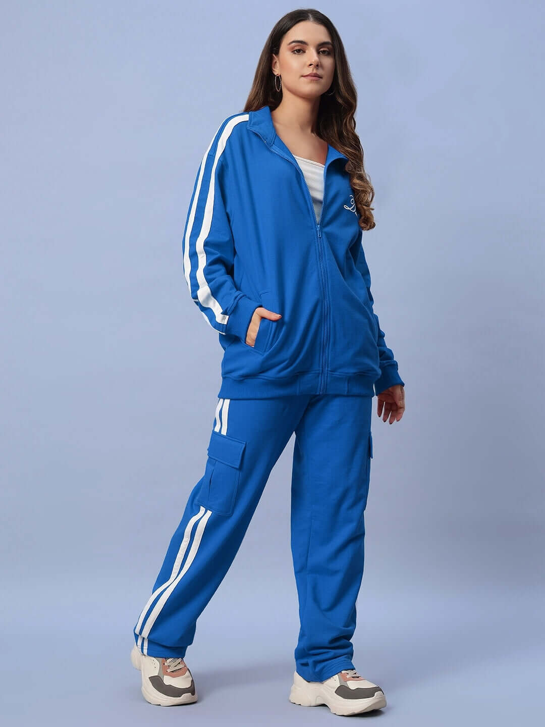 Model wearing Women's Scotia Co-ord Set in royal blue, showcasing a sporty jacket and pants made of 100% cotton terry fabric.