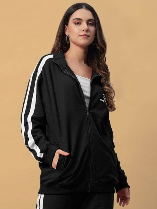 Woman wearing the Women's Scotia Jacket in black with stripes, showcasing modern design and comfort by DUDS.