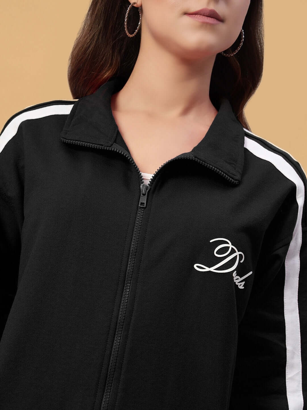Woman wearing black Women's Scotia Jacket from Duds with white stripes on sleeves.
