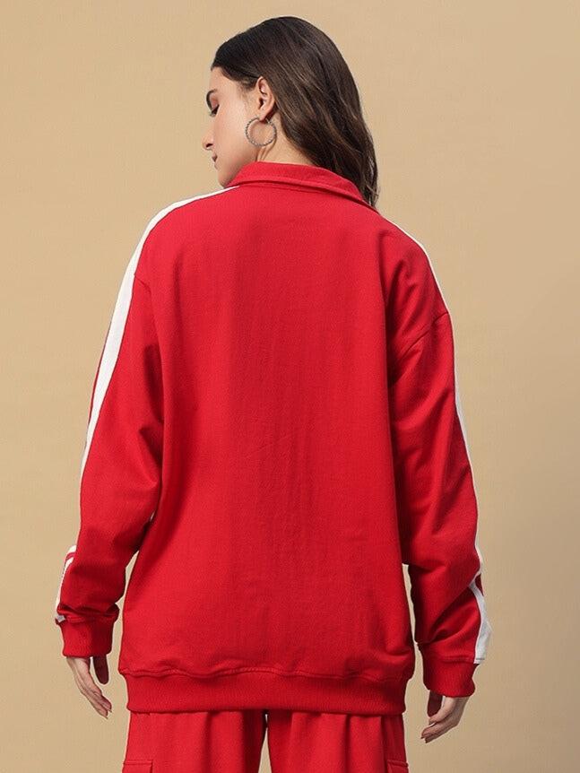 Alt Tag: Back view of a woman wearing a red Scotia jacket by DUDS, featuring white side stripes. Perfect for custom fit orders.