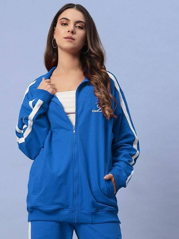 Woman wearing Women's Scotia Jacket in Royal Blue, hands in pockets.