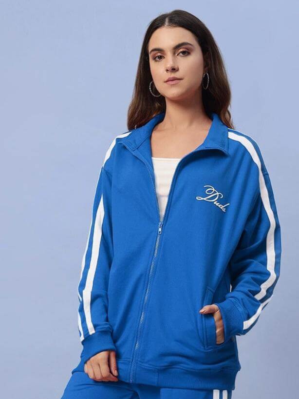Model wearing women's royal blue Scotia Jacket by DUDS with white stripes, showcasing tailored fit and casual style.