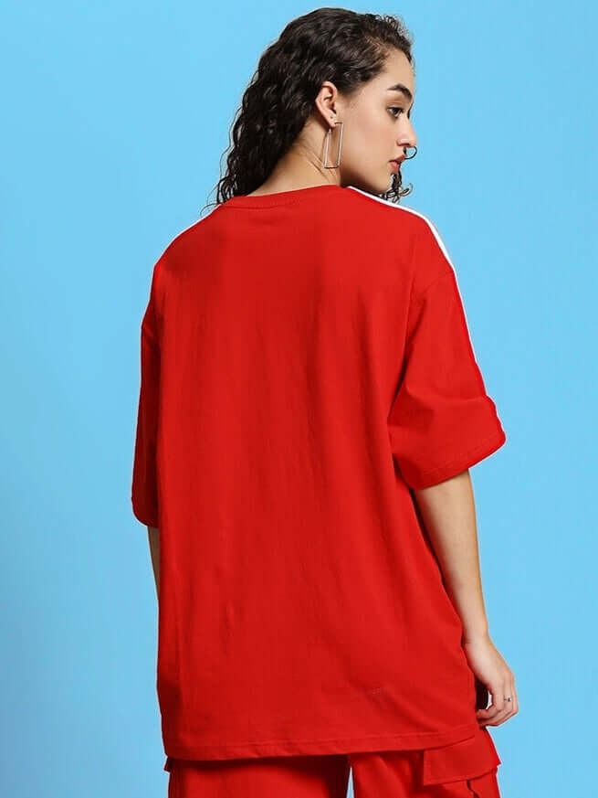 Model wearing women's red over-sized t-shirt in premium cotton fabric, viewed from the back.