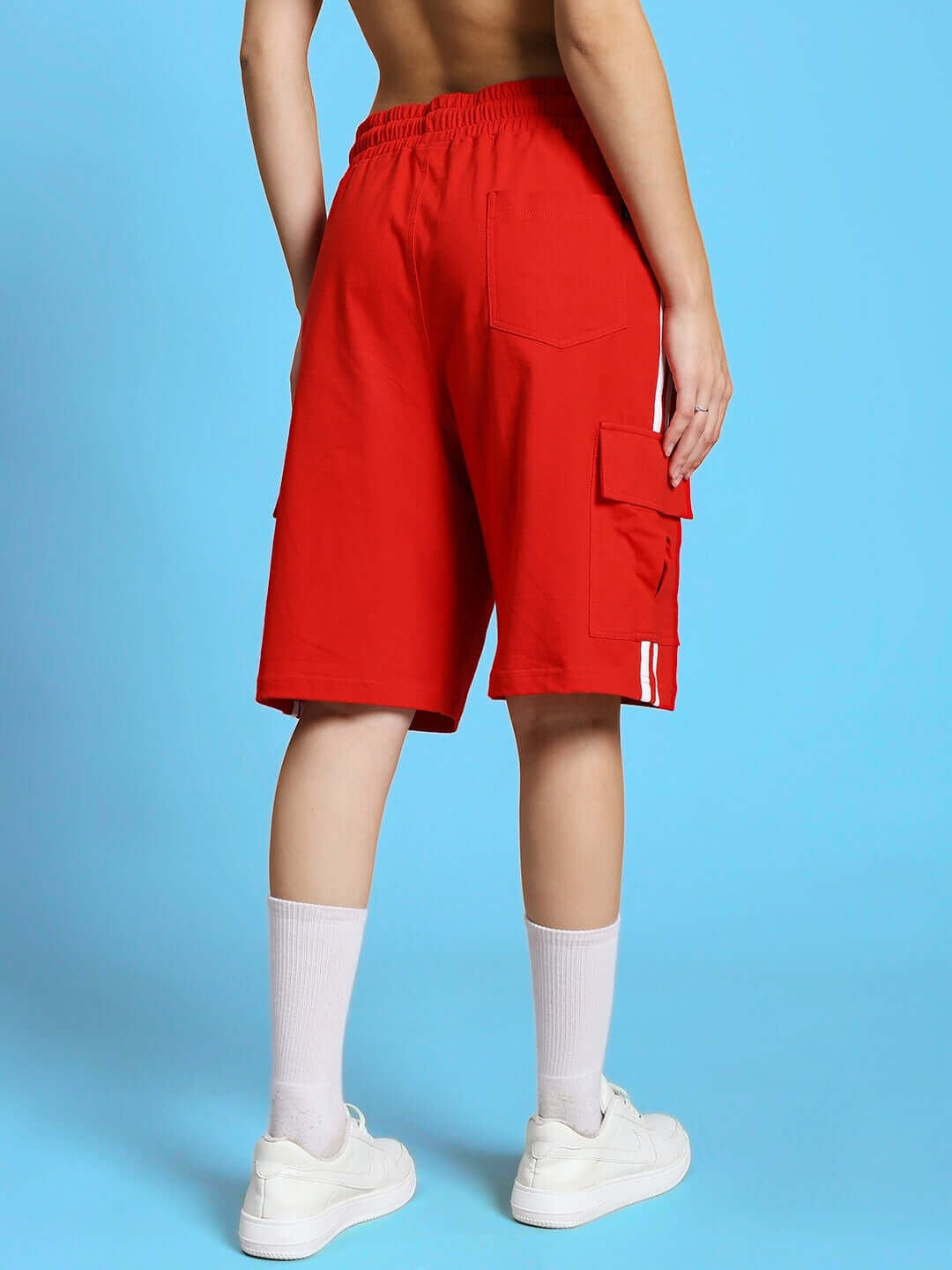 Back view of model wearing red women's Scotia regular fit shorts, showcasing pockets and relaxed design, ideal for casual wear.