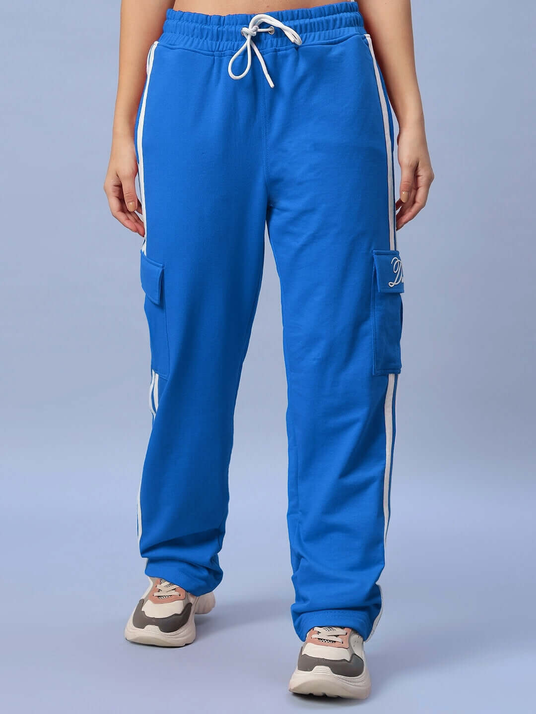 Woman wearing royal blue Scotia stripe joggers with pockets, showcasing casual style and comfort, perfect for customizing the fit.