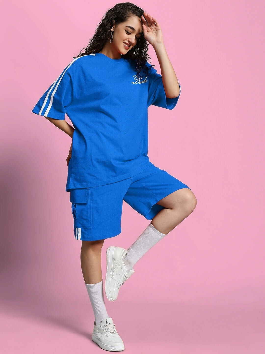 Woman smiling in WOMEN'S SCOTIA SUMMER CO-ORD SET ROYAL BLUE, casual and stylish.