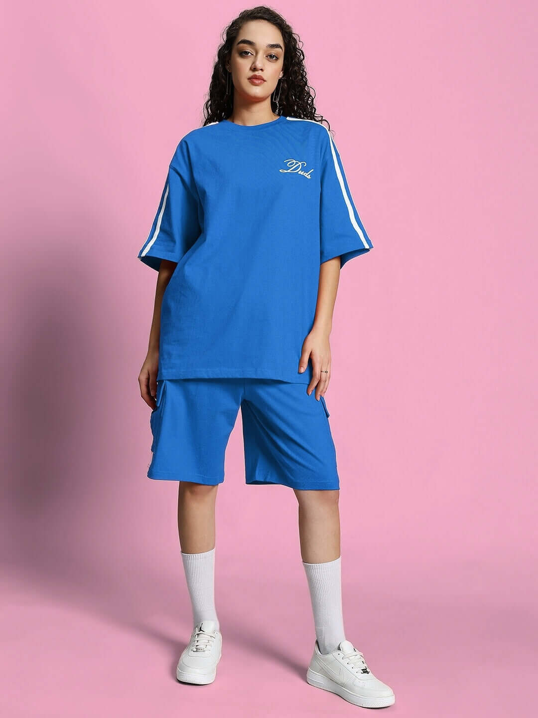 Woman wearing WOMEN'S SCOTIA SUMMER CO-ORD SET ROYAL BLUE against pink background