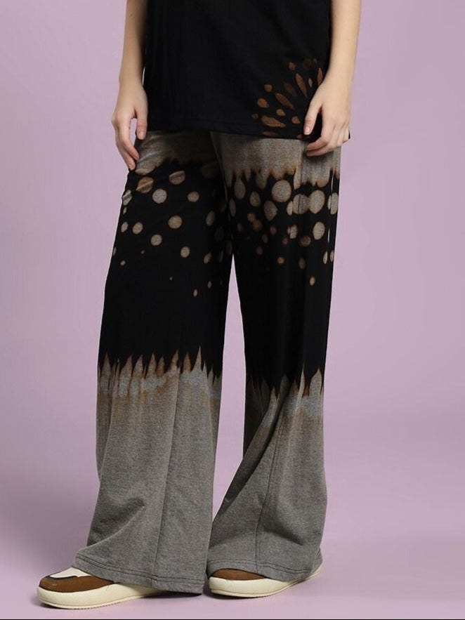 Model wearing WOMEN'S SHADOW SWIRL TIE-DYE JOGGER BLACK, showcasing unique black tie-dye pattern and comfortable fit.