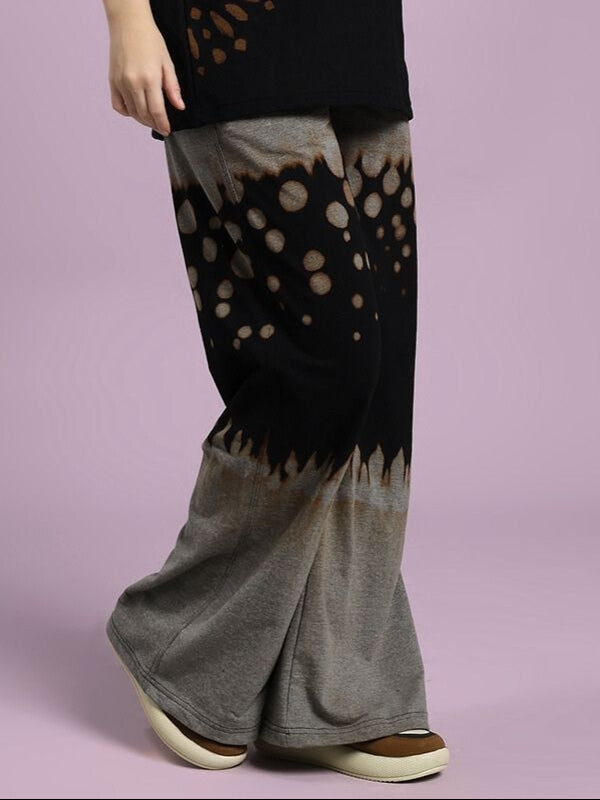 Person wearing WOMEN'S SHADOW SWIRL TIE-DYE JOGGER BLACK with unique tie-dye pattern and comfortable fit.