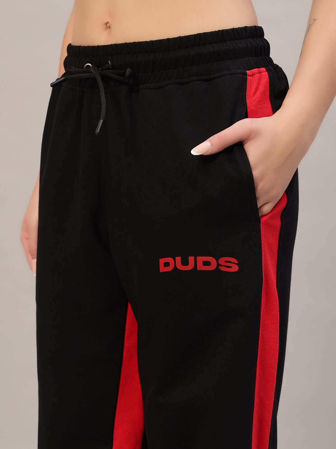 Women's black-red side seam baggy joggers by DUDS, featuring elastic waist, experienced tailoring, customizable fit available.