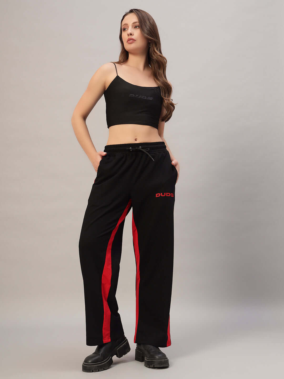 Woman wearing DUDS women's side seam baggy joggers in black-red, made-to-order style with custom fit option available.